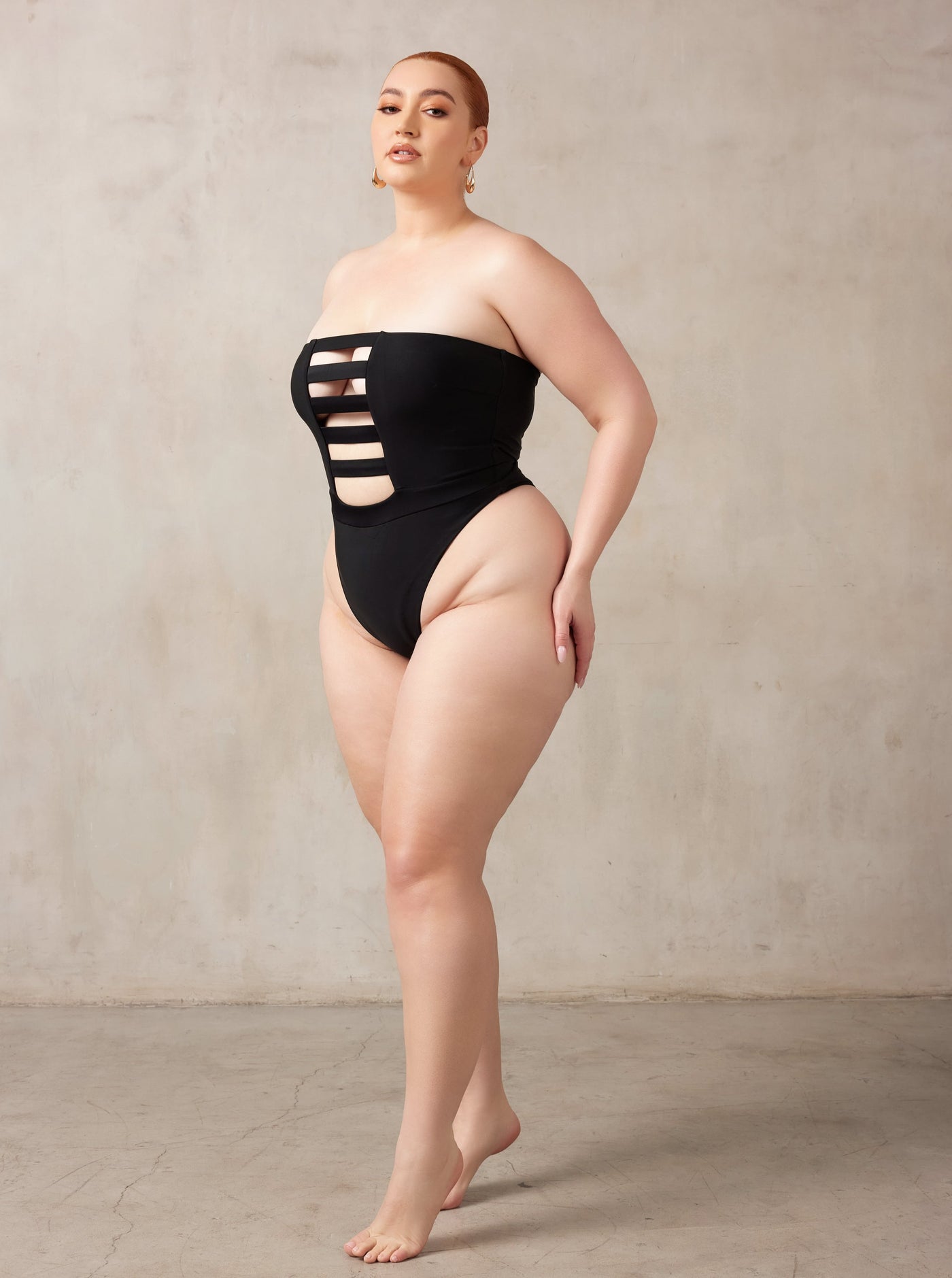 MBM Swim, Marcia B Maxwell high-cut Black cut-out one-piece swimsuit on beautiful midsize curve model, black owned #color_black