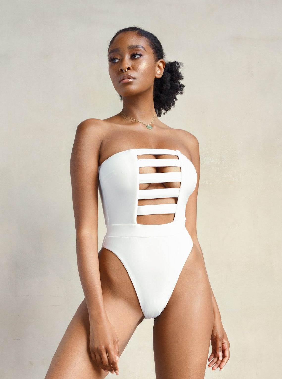 MBM Swim, Marcia B Maxwell high-cut white cut-out one-piece swimsuit on beautiful dark skinned model, black owned #color_white