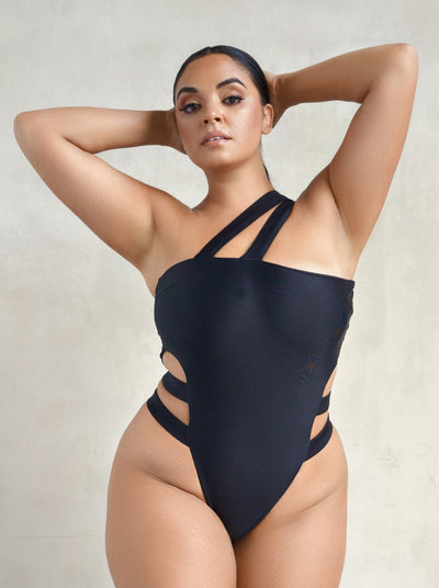 MBM Swim by Marcia B Maxwell Discovery black strappy one shoulder one-piece swimsuit on plus size model #color_black