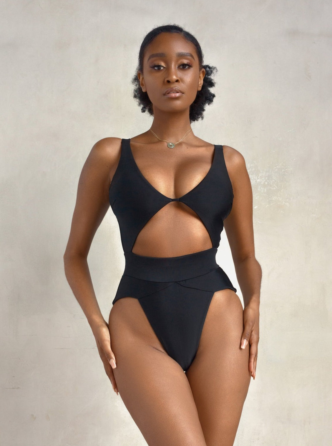 Black model natural hair wearing MBM Swim by Marcia B Maxwell black Aspire one-piece monokini #color_black