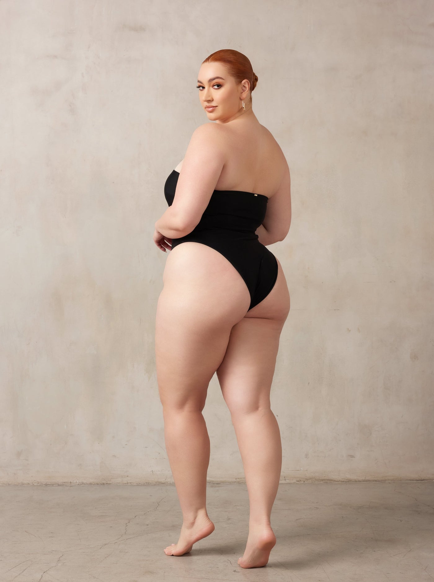 MBM Swim, Marcia B Maxwell high-cut Black cut-out one-piece swimsuit on beautiful midsize curve model, black owned #color_black