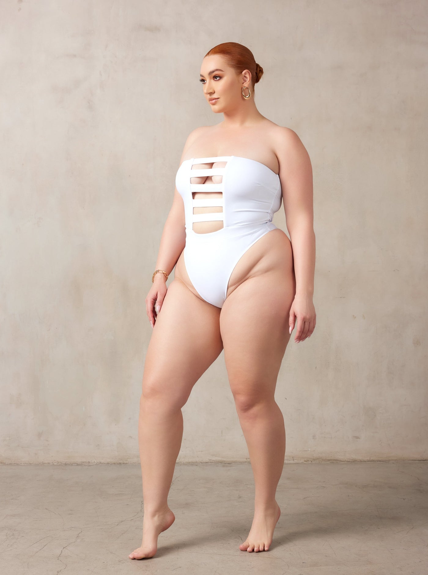 MBM Swim, Marcia B Maxwell high-cut white cut-out one-piece swimsuit on beautiful curve midsize model #color_white